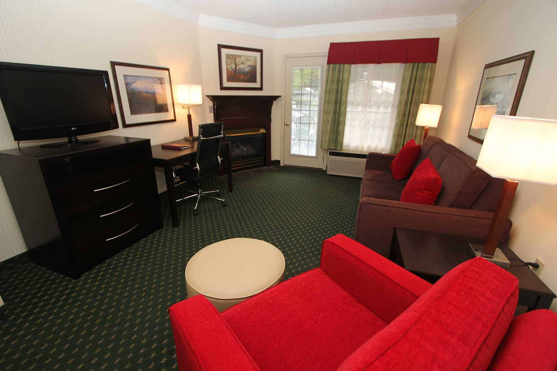 Cozy sitting room with fireplace in king suite at Black Bear Inn & Suites