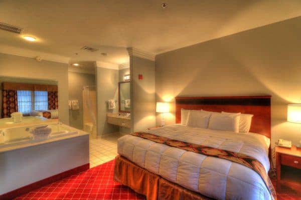 king bedroom with jacuzzi tub in penthouse suite