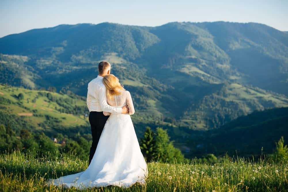 newly weds looking at the mountains