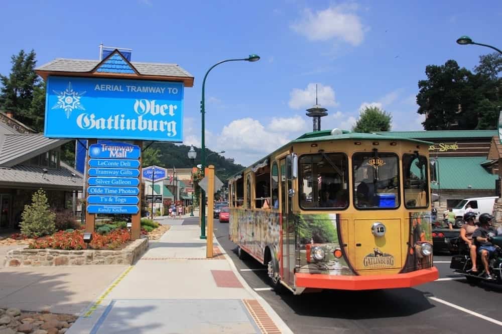 Gatlinburg trolley in front of Ober Gatlinburg sign
